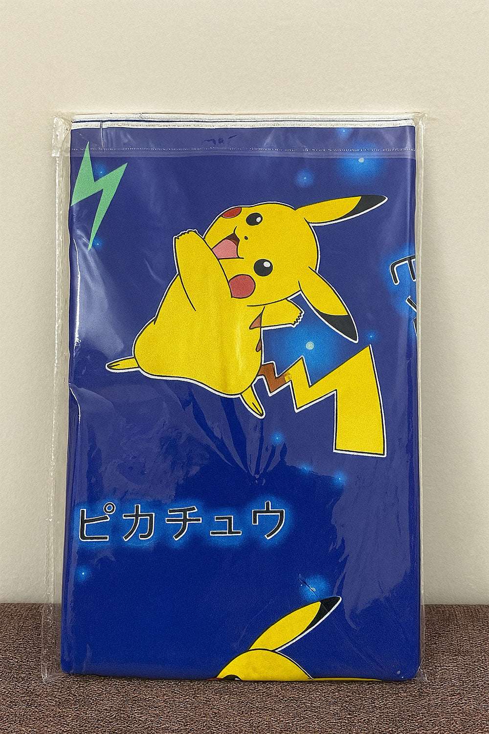 Baby Changing Sheet Pikachu Wrapper Against Textured Wall